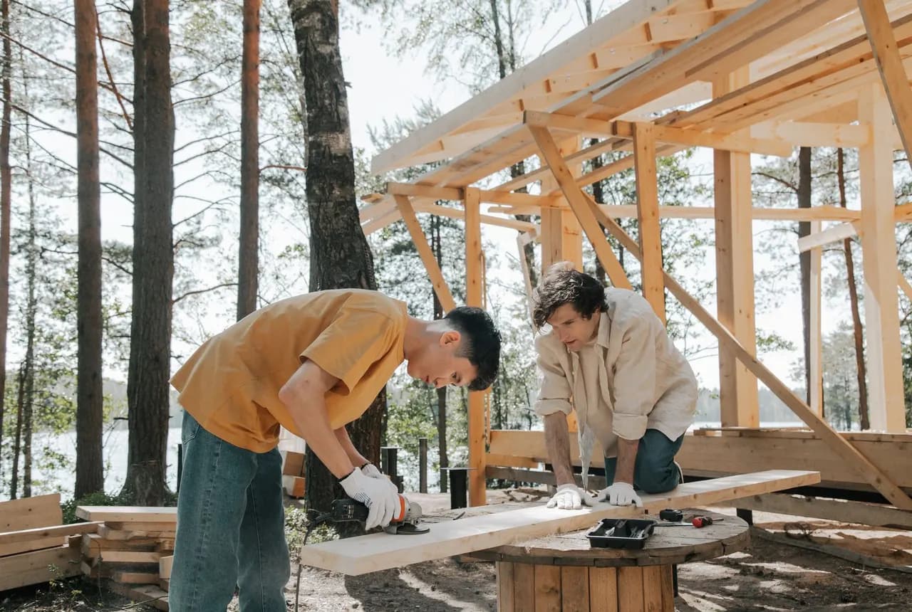 Carpenters working on an outdoor timber frame