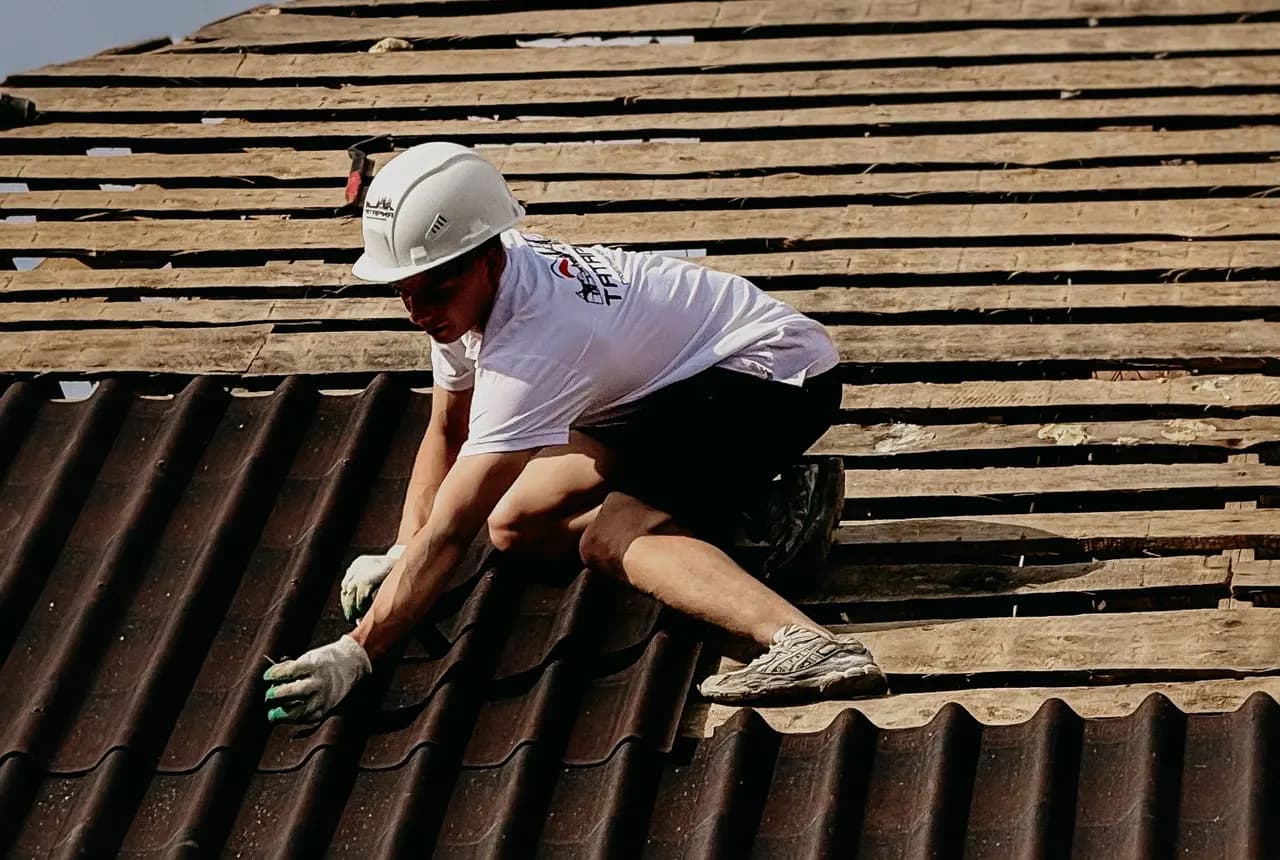 Roofer repairing a tiled roof